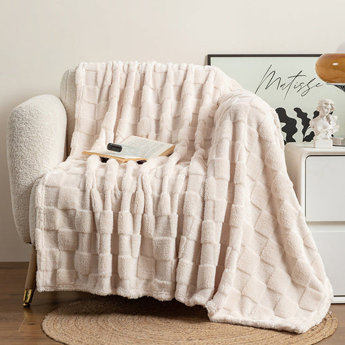 Checked jacquard throw blanket draped over a sofa