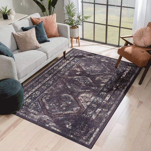 Black and burgundy washable area rug, 6 by 9 feet, in a living room