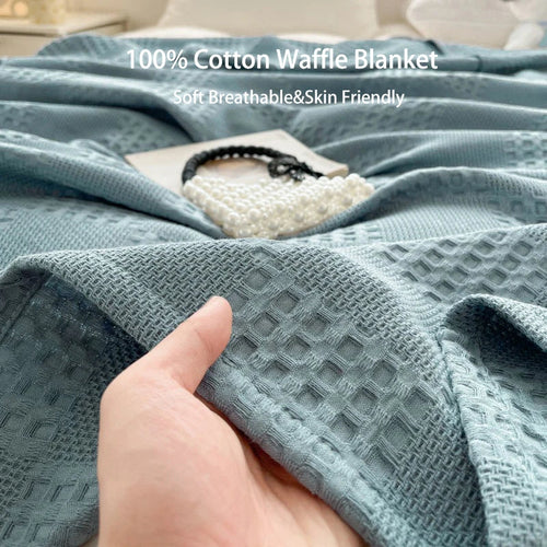 Cotton waffle throw blanket on a bed